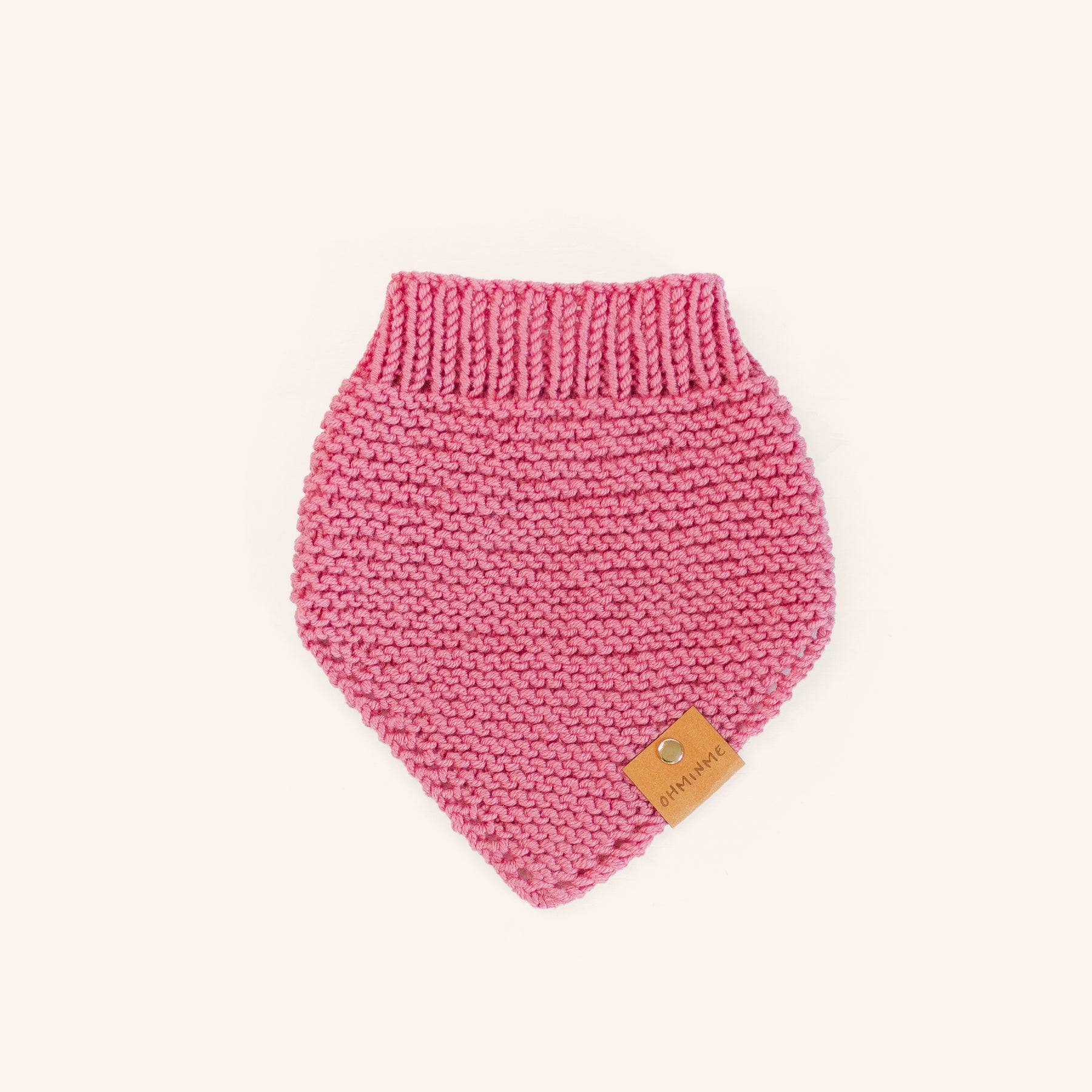 blush pink dog bandana in knitted merino wool with a brown OHMINME label and gold rivet