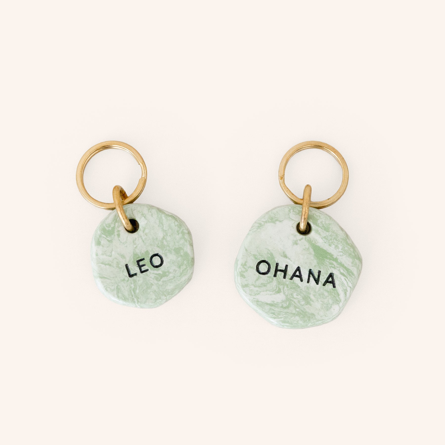 personalised ID dog tags in green marble look with brass split ring, close-up
