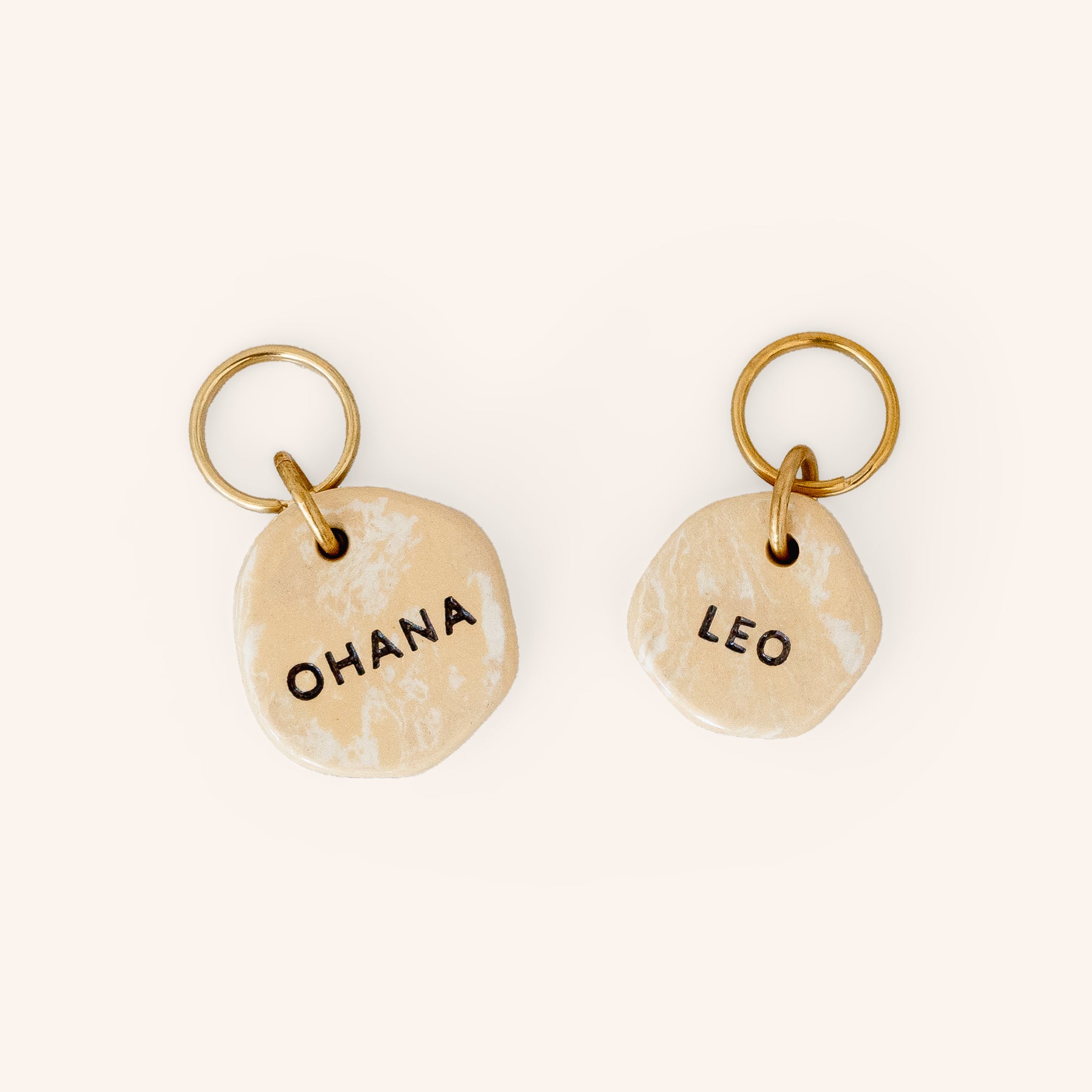 small and large size personalised dog tags in travertine look earth clay, close-up