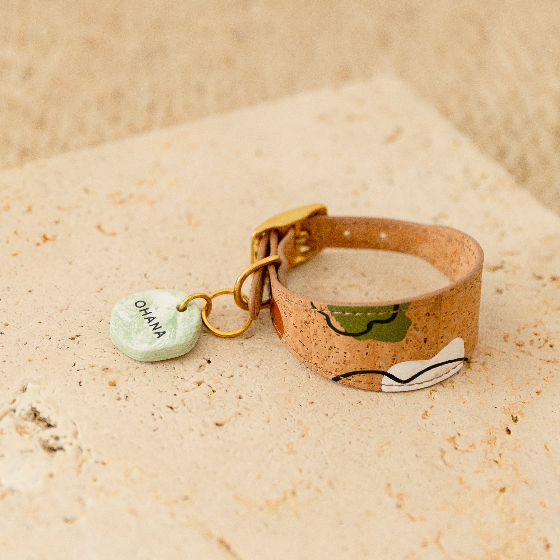 personalised dog ID tag in green marble look, attached on a brown cork leather dog collar with hand-painted details