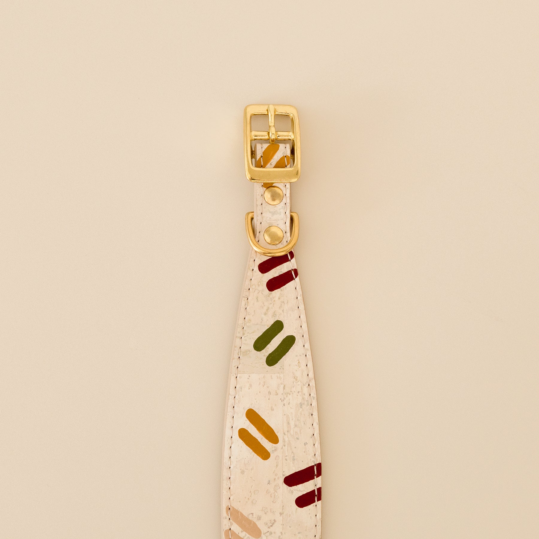 wide dog collar in vegan cork leather featuring hand painted design and brass hardware, close-up