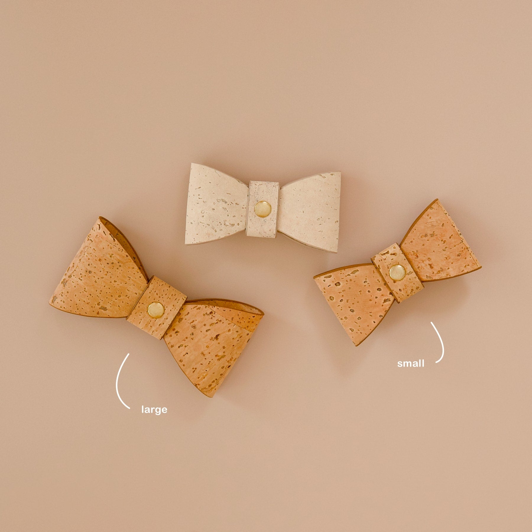 Three cork leather dog bow ties, one cream and two mocha brown in small and large sizes