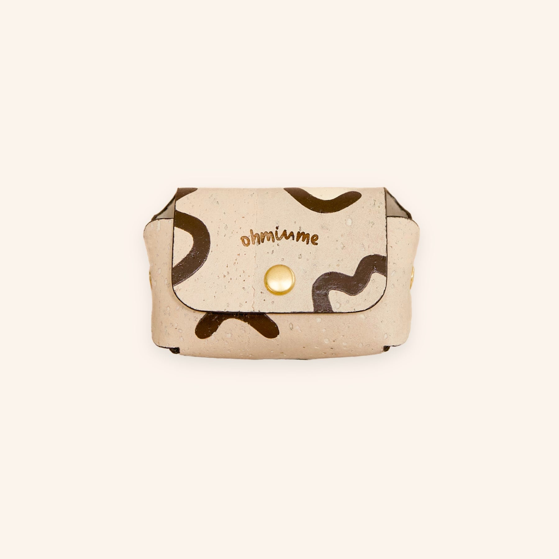 Cream beige dog poop bag holder in vegan cork leather with “ohminme” engraving, front view.