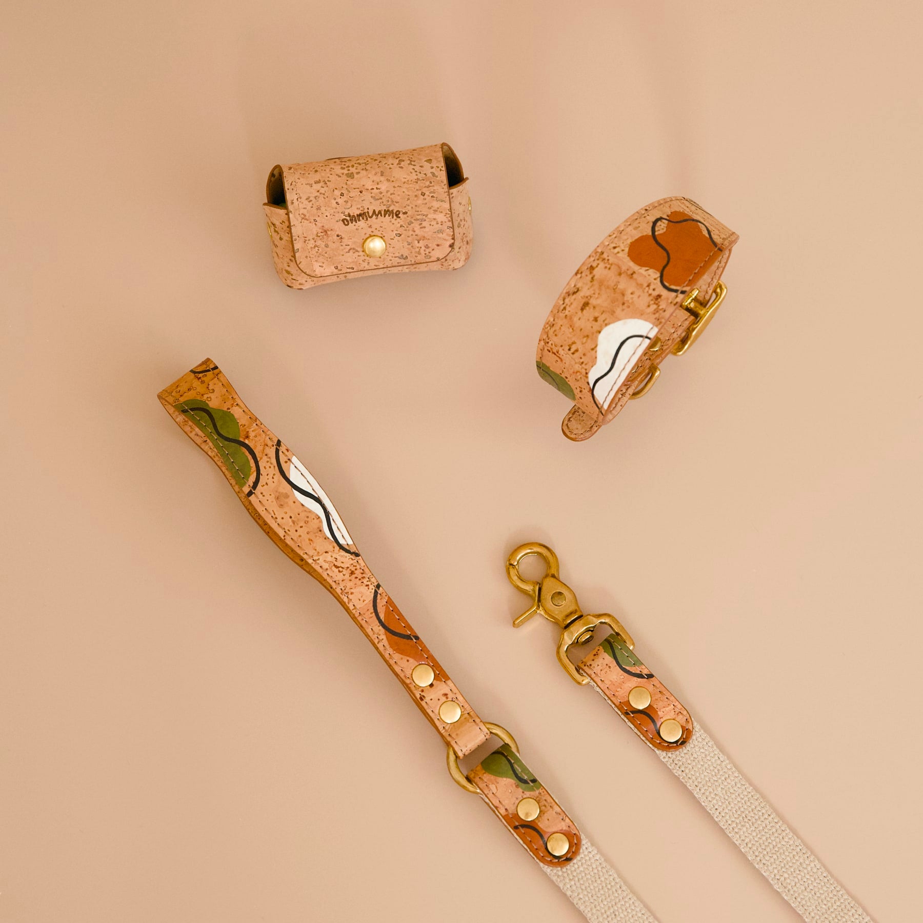 Cork leather no-dangle poop bag holder, dog collar, and matching leash in brown tan with hand-painted details and brass hardware