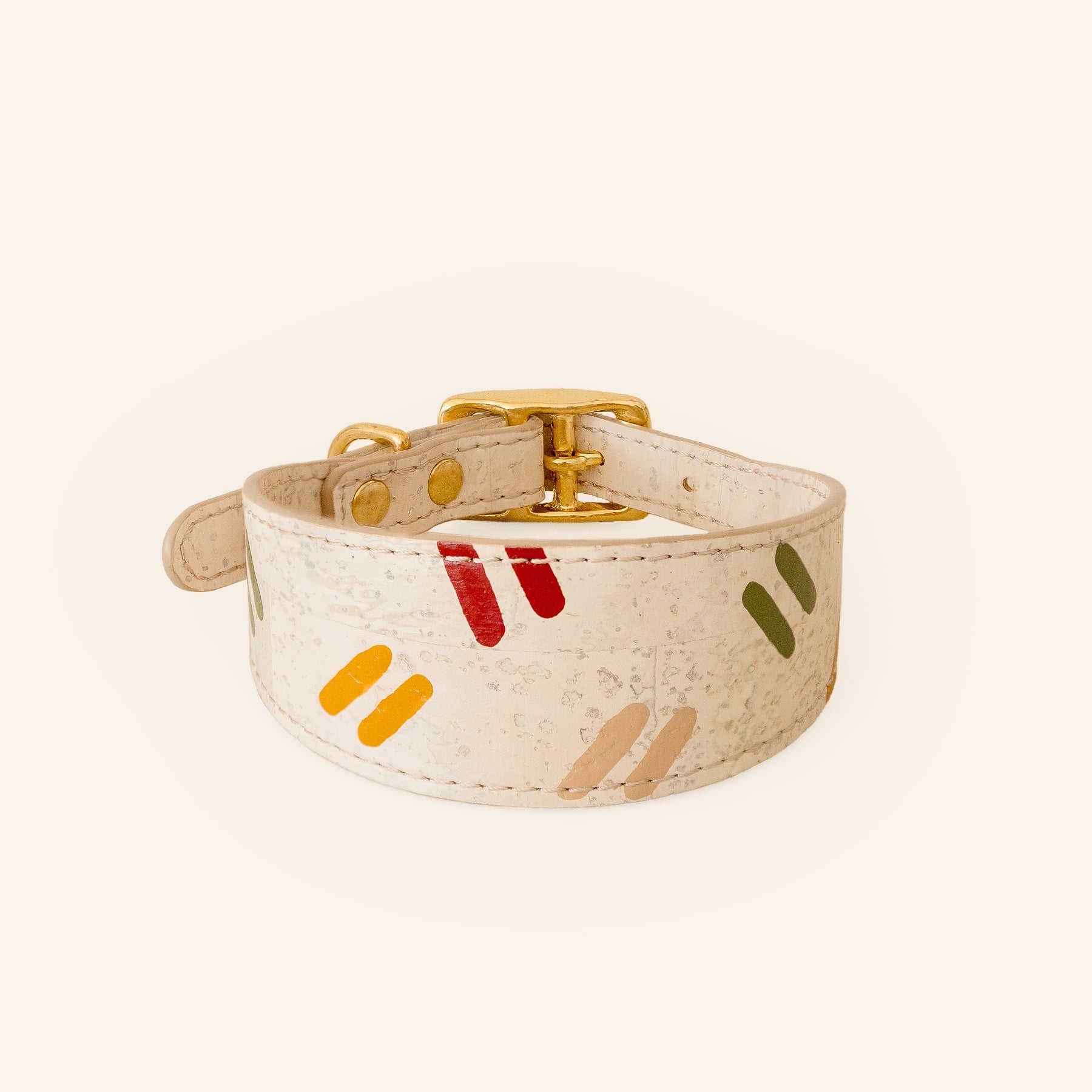Dog collar with colorful patterns in vegan cork leather with brass hardware, front view.
