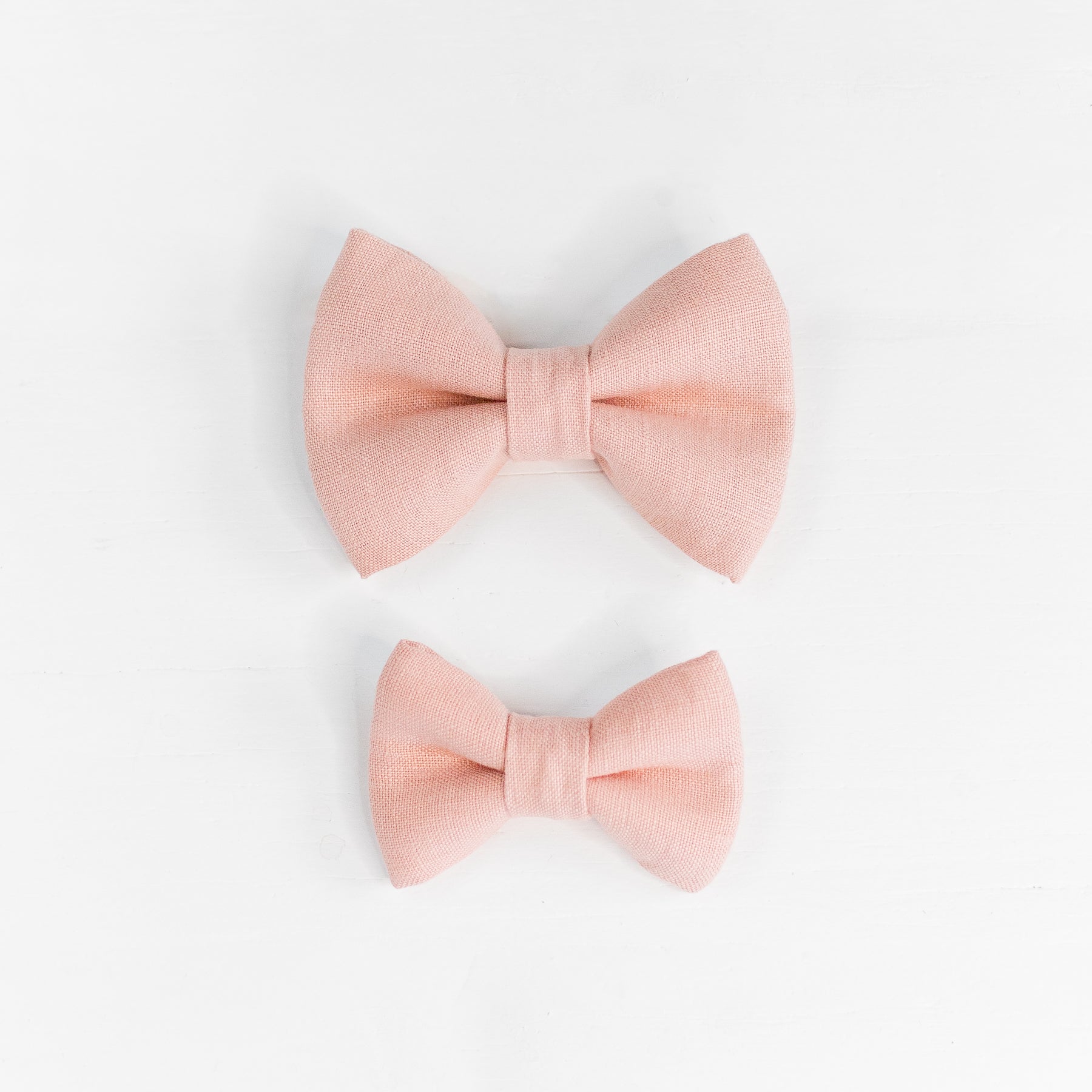 Two linen dog bow ties in pink.