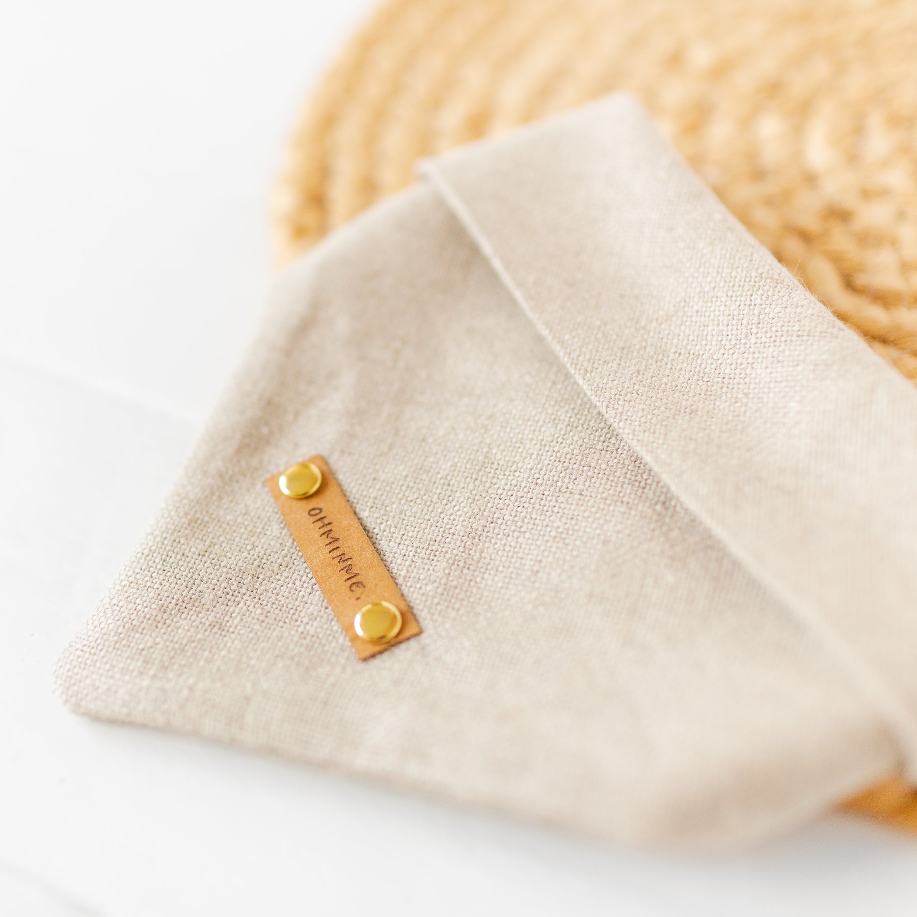 natural hemp dog bandana with washable paper label and brass rivets, close-up