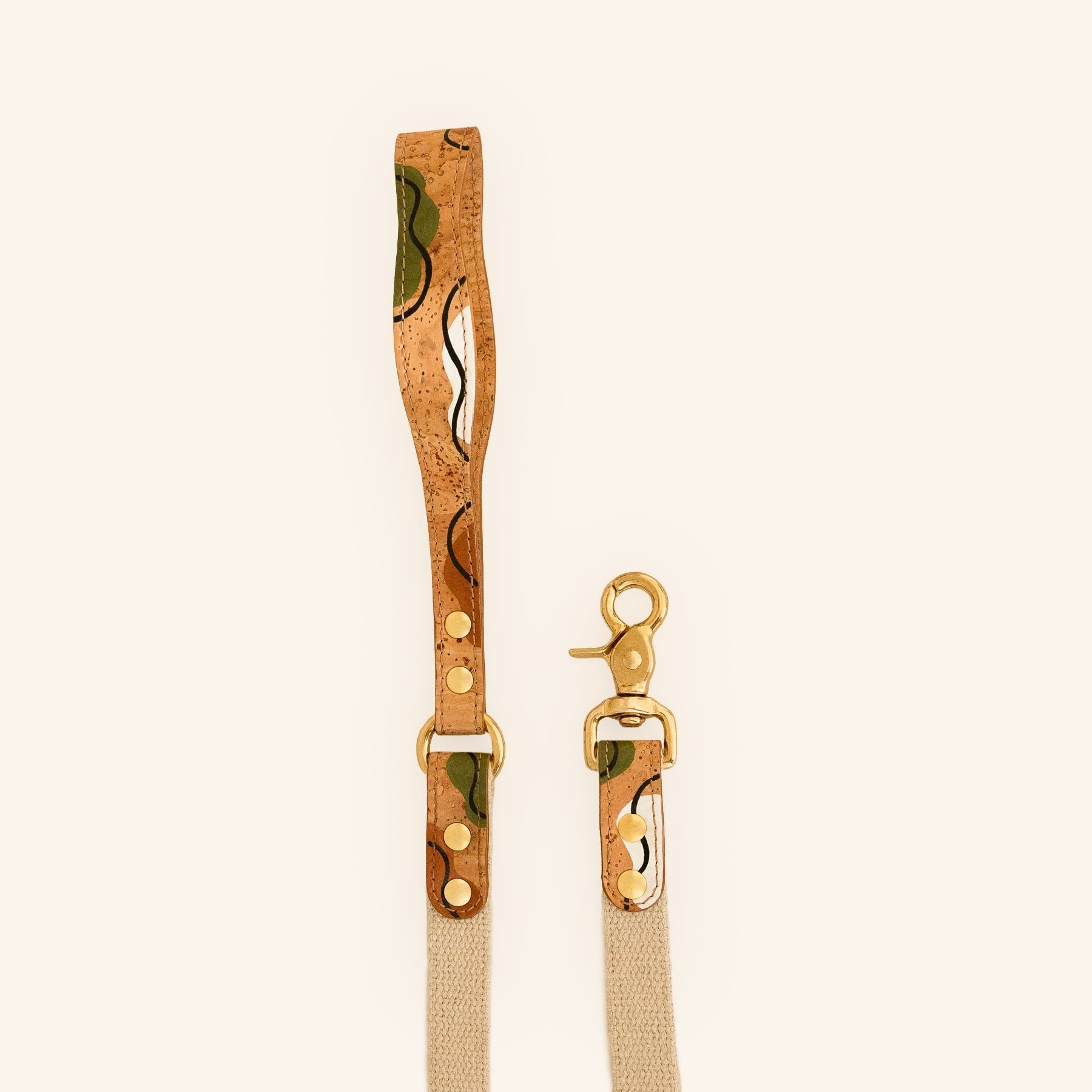 Hemp dog leash with brown cork handle and brass hardware.