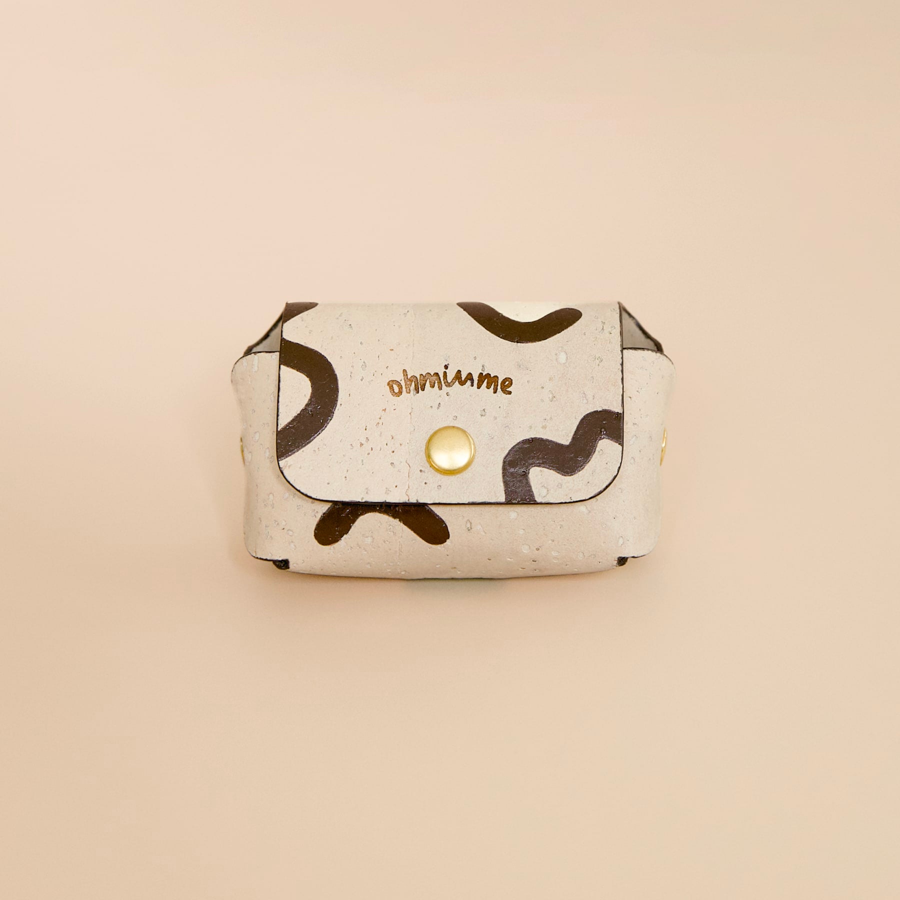 Cream beige cork leather dog poop bag holder with “ohminme” engraving, Vegur design, hand-painted, front view