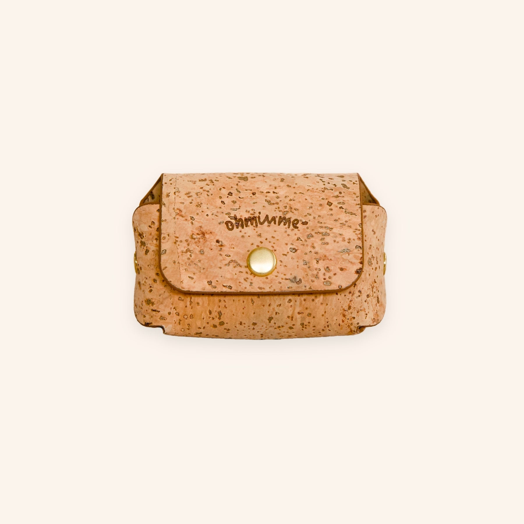 Mocha brown dog poop bag holder in natural cork leather with a brass button, engraved with “ohminme”, front view.