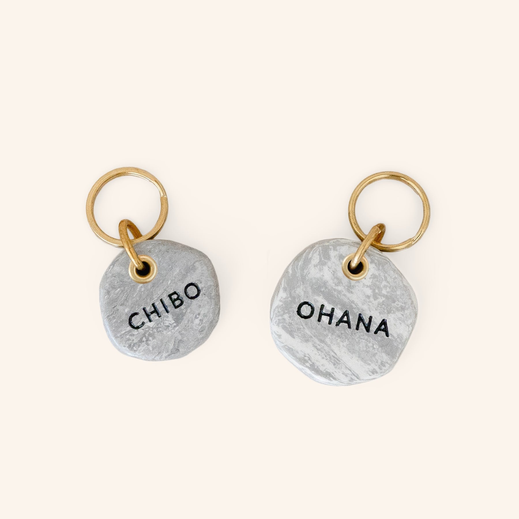 small and large marble look personalised dog ID tags engraved with name, close-up