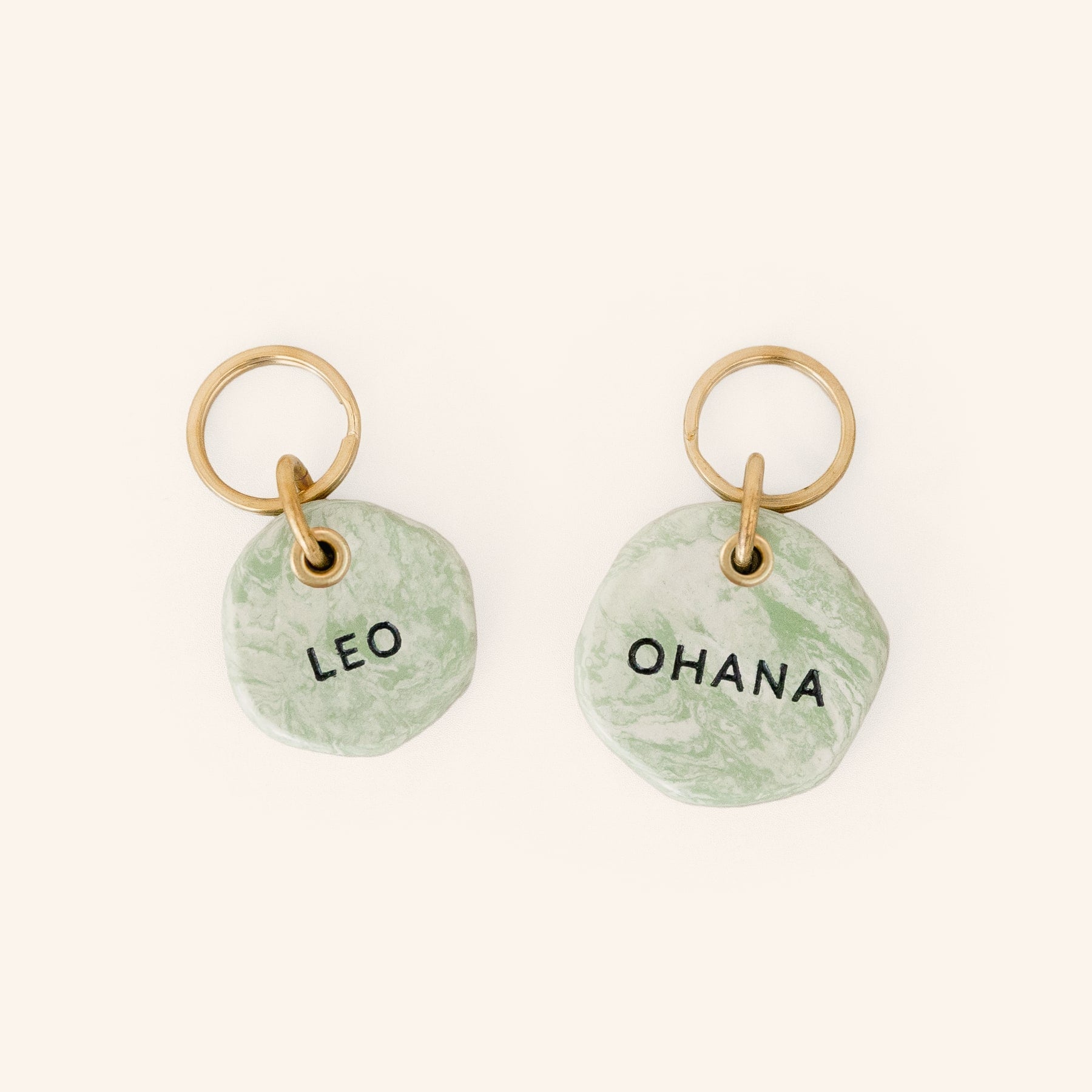 personalised dog ID tags in green marble look with brass split ring, close-up