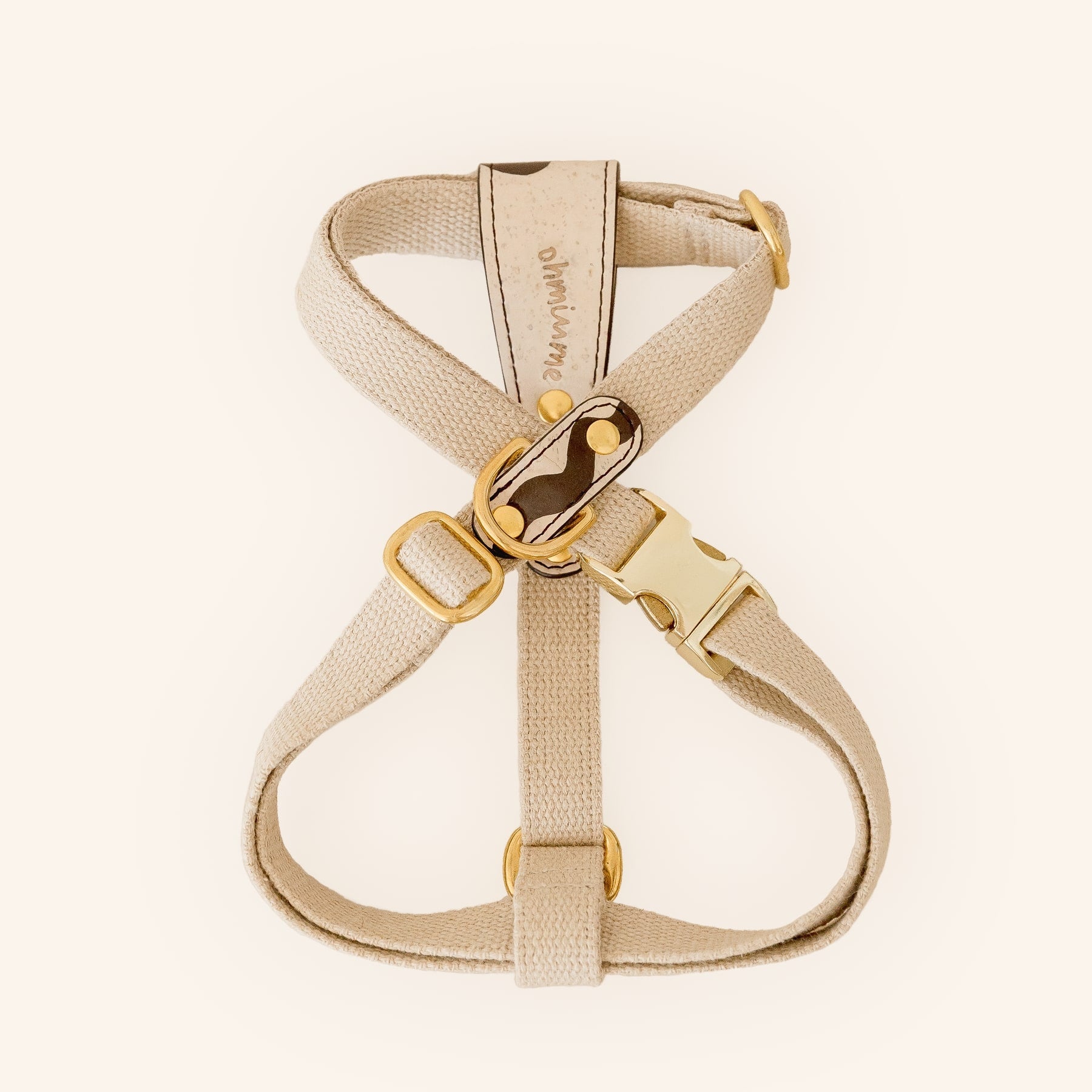 Beige dog harness in vegan cork leather and hemp with brass hardware, top view.