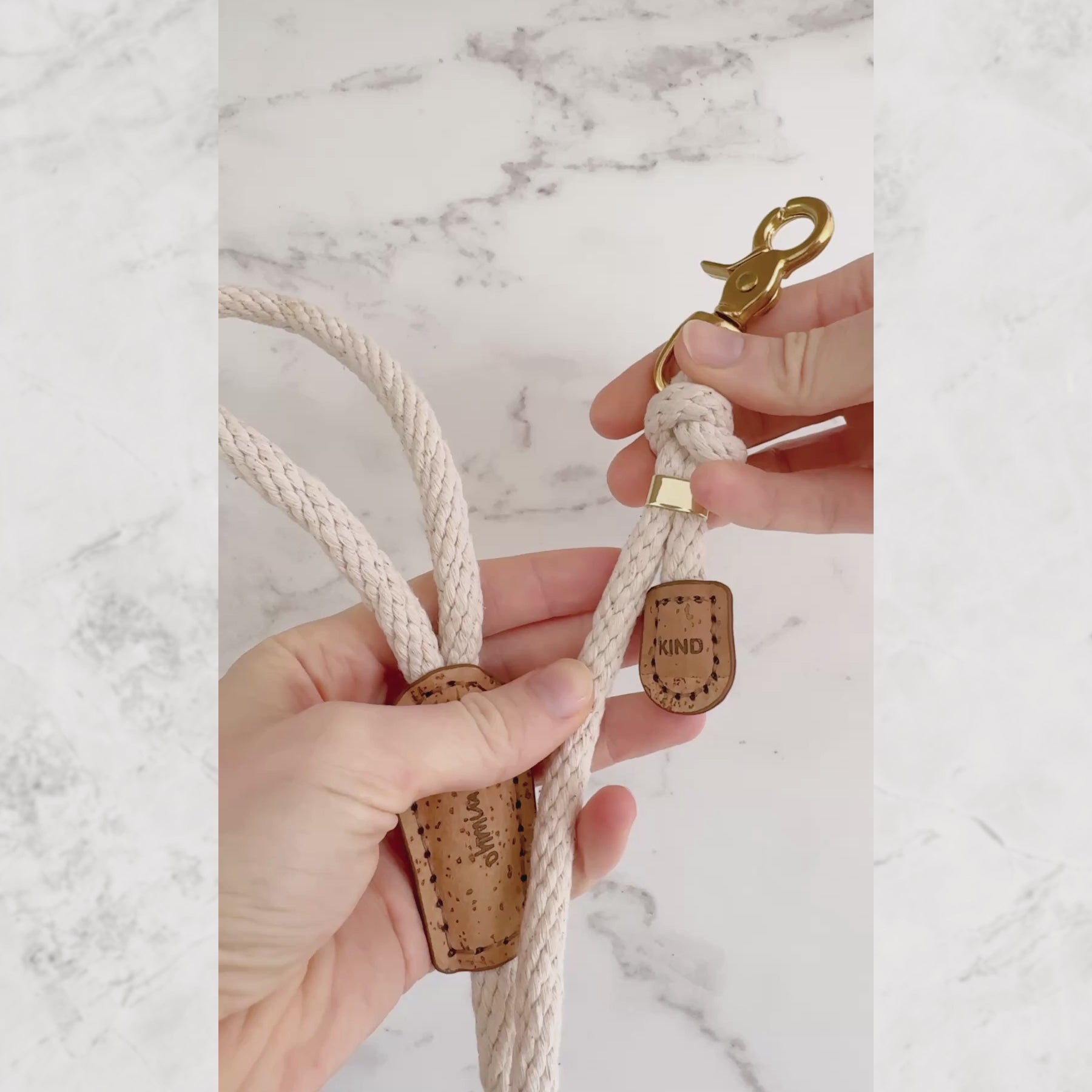 Showing engraved “Be Kind” message on cotton rope dog leash with cork leather detail and brass hardware